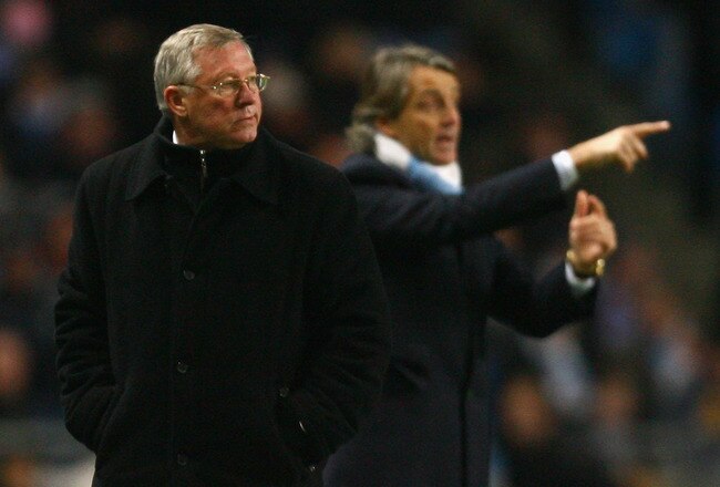 MANCHESTER, ENGLAND - JANUARY 19:  Manchester United Manager Sir Alex Ferguson looks on as Manchester City Manager Roberto Mancini gestures during the Carling Cup Semi Final match between Manchester City and Manchester United at the City of Manchester Stadium on January 19, 2010 in Manchester, England.  (Photo by Alex Livesey/Getty Images)
