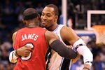 ORLANDO, FL - FEBRUARY 08:  LeBron James #6 of the Miami Heat hugs Dwight Howard #12 of the Orlando Magic during the game at Amway Center on February 8, 2012 in Orlando, Florida.   NOTE TO USER: User expressly acknowledges and agrees that, by downloading and or using this Photograph, user is consenting to the terms and conditions of the Getty Images License Agreement.  (Photo by Sam Greenwood/Getty Images)