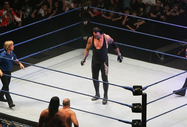 SYDNEY, AUSTRALIA - JUNE 15:  The Undertaker and ECW Champion Kane stand in the ring as the look down to Bam Neely, Chavo Guerrero, and The Great Khali during WWE Smackdown at Acer Arena on June 15, 2008 in Sydney, Australia.  (Photo by Gaye Gerard/Getty Images)