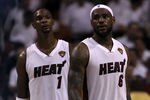 MIAMI, FL - JUNE 12:  (L-R) Chris Bosh #1 and LeBron James #6 of the Miami Heat look on against the Dallas Mavericks in Game Six of the 2011 NBA Finals at American Airlines Arena on June 12, 2011 in Miami, Florida. NOTE TO USER: User expressly acknowledges and agrees that, by downloading and/or using this Photograph, user is consenting to the terms and conditions of the Getty Images License Agreement.  (Photo by Ronald Martinez/Getty Images)