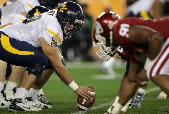 GLENDALE, AZ - JANUARY 02:  Center Mike Dent #68 of the West Virginia Mountaineers gets ready to snap the ball against the Oklahoma Sooners at the Tostito's Fiesta Bowl at University of Phoenix Stadium January 2, 2008 in Glendale, Arizona.  (Photo by Doug Pensinger/Getty Images)