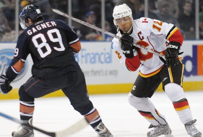 EDMONTON, AB - SEPTEMBER 30: Jarome Iginla #12 of the Calgary Flames stick handles the puck past Sam Gagner #89 of the Edmonton Oilers in the third period during a preseason NHL game on September 30, 2008 at Rexall Arena in Edmonton, Canada. Calgary beat the Edmonton Oilers 4-0. (Photo by Jimmy Jeong/Getty Images)