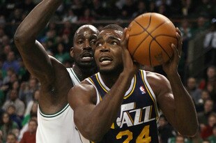 BOSTON, MA - JANUARY 21:  Paul Millsap #24 of the Utah Jazz heads for the net as Kevin Garnett #5 of the Boston Celtics defends on January 21, 2011 at the TD Garden in Boston, Massachusetts.  NOTE TO USER: User expressly acknowledges and agrees that, by downloading and/or using this Photograph, User is consenting to the terms and conditions of the Getty Images License Agreement.  (Photo by Elsa/Getty Images)