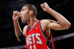 ATLANTA, GA - DECEMBER 07:   Brook Lopez #11 of the New Jersey Nets reacts after being called for a foul against the Atlanta Hawks at Philips Arena on December 7, 2010 in Atlanta, Georgia.  NOTE TO USER: User expressly acknowledges and agrees that, by downloading and/or using this Photograph, User is consenting to the terms and conditions of the Getty Images License Agreement.  (Photo by Kevin C. Cox/Getty Images)