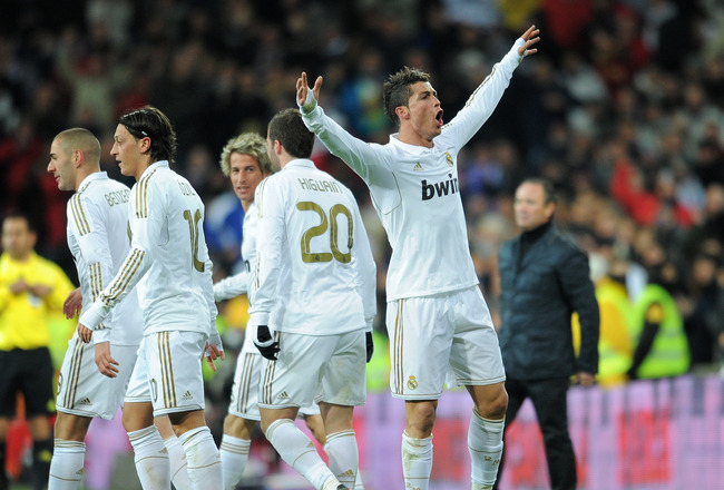 MADRID, SPAIN - FEBRUARY 12:  Cristiano Ronaldo (R) of Real Madrid celebrates scoring his sides second goal during the la Liga match between Real Madrid and Levante at Estadio Santiago Bernabeu on February 12, 2012 in Madrid, Spain.  (Photo by Jasper Juinen/Getty Images)