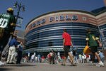 DETROIT - SEPTEMBER 11: Fans mingle outside the entrance of Ford Field before the kickoff of the Season Opening game between the Green Bay Packers and the Detroit Lions on September 11, 2005 at Ford Field in Detroit, Michigan.  (Photo by Jonathan Ferrey/Getty Images)