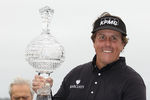 PEBBLE BEACH, CA - FEBRUARY 12:  Phil Mickelson is awarded with the tournament trophy after winning with an eight-under-par 64 as actor Clint Eastwood looks on during the AT&T Pebble Beach National Pro-Am at Pebble Beach Golf Links on February 12, 2012 in Pebble Beach, California.  (Photo by Ezra Shaw/Getty Images)