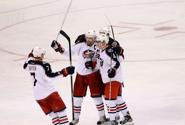DALLAS, TX - DECEMBER 29:  Jeff Carter #7 , Rick Nash #61, Nikita Nikitin #6 and John Moore #4 of the Columbus Blue Jackets celebrate a goal against the Dallas Stars at American Airlines Center on December 29, 2011 in Dallas, Texas.  (Photo by Ronald Martinez/Getty Images)