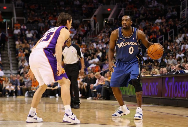 PHOENIX - DECEMBER 19:  Gilbert Arenas #0 of the Washington Wizards hanldles the ball during the NBA game against the Phoenix Suns at US Airways Center on December 19, 2009 in Phoenix, Arizona. The Suns defeated the Wizards 121-95. NOTE TO USER: User expressly acknowledges and agrees that, by downloading and or using this photograph, User is consenting to the terms and conditions of the Getty Images License Agreement.  (Photo by Christian Petersen/Getty Images)