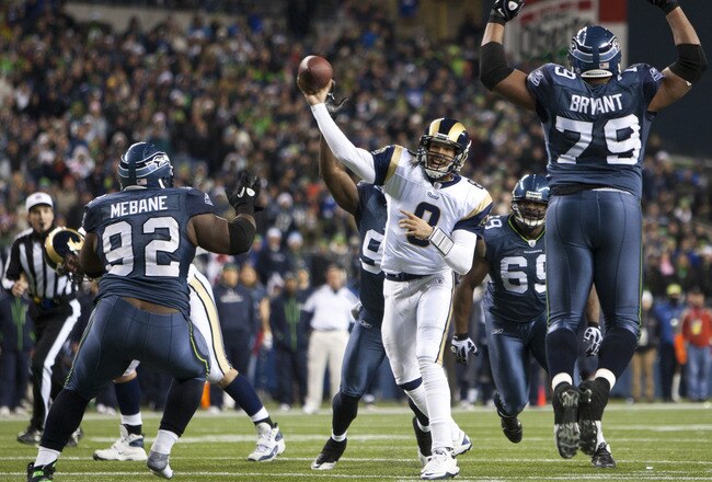 SEATTLE, WA - DECEMBER 12:  Sam Bradford #8 of the St. Louis Rams is surrounded by the Seattle Seahawks defense at CenturyLink Field December 12, 2011 in Seattle, Washington. Seattle won 33-13. (Photo by Jay Drowns/Getty Images)
