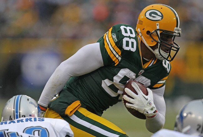 GREEN BAY, WI - JANUARY 01: Jermichael Finley #88 of the Green Bay Packers breaks away from Chris Harris #43 of the Detroit Lions for a first down at Lambeau Field on January 1, 2012 in Green Bay, Wisconsin. (Photo by Jonathan Daniel/Getty Images)
