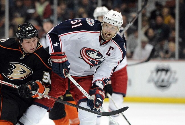 ANAHEIM, CA - FEBRUARY 03:  Rick Nash #61 of the Columbus Blue Jackets fends off Matt Beleskey #39 of the Anaheim Ducks as he carries the puck during the second period at Honda Center on February 3, 2012 in Anaheim, California.  (Photo by Harry How/Getty Images)