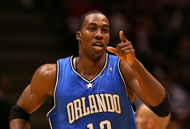 EAST RUTHERFORD, NJ - NOVEMBER 16:  Dwight Howard #12 of the Orlando Magic celebrates a basket against the New Jersey Nets during their game at the Izod Center on November 16, 2007 in East Rutherford, New Jersey.The Magic defeated the Nets 95-70. NOTE TO USER: User expressly acknowledges and agrees that, by downloading and/or using this Photograph, User is consenting to the terms and conditions of the Getty Images License Agreement.  (Photo by Jim McIsaac/Getty Images)