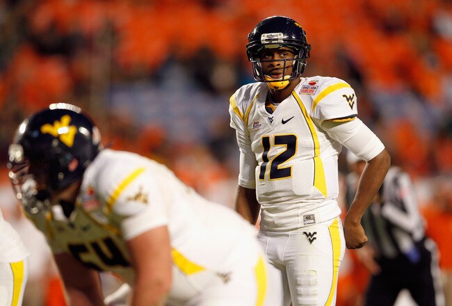 MIAMI GARDENS, FL - JANUARY 04:  Geno Smith #12 of the West Virginia Mountaineers calls signals out of the shotgun formation against the Clemson Tigers during the Discover Orange Bowl at Sun Life Stadium on January 4, 2012 in Miami Gardens, Florida.  (Photo by Mike Ehrmann/Getty Images)