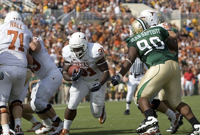 WACO, TX - NOVEMBER 14:  Running back Cody Johnson #31 of the Texas Longhorns carries the ball into the end zone during the first half against tackle Nicolas Jean-Baptiste #90 of the Baylor Bears on November 14, 2009 at Floyd Casey Stadium in Waco, Texas.  The Longhorns beat the Bears 47-14.  (Photo by Tom Pennington/Getty Images)
