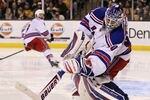 BOSTON, MA - FEBRUARY 14:  Henrik Lundqvist #30 of the New York Rangers clears the puck in the third period against the Boston Bruins on February 14, 2012 at TD Garden in Boston, Massachusetts. The New York Rangers defeated the Boston Bruins 3-0.  (Photo by Elsa/Getty Images)