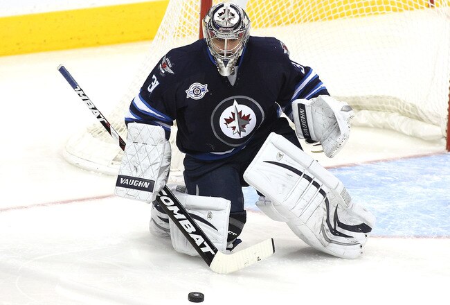 WINNIPEG, CANADA - FEBRUARY 7: Ondrej Pavelec #31 of the Winnipeg Jets blocks a shot on goal during a game against the Toronto Maple Leafs in NHL action at the MTS Centre on February 7, 2012 in Winnipeg, Manitoba, Canada. (Photo by Marianne Helm/Getty Images)