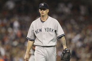 DETROIT, MI - OCTOBER 04:  A J Burnett #34 of the New York Yankees pitches in the sixth inning during Game Four of the American League Divison Series against the Detroit Tigers at Comerica Park on October 4, 2011 in Detroit, Michigan. The Yankees defeated the Tigers 10-1.  (Photo by Leon Halip/Getty Images)