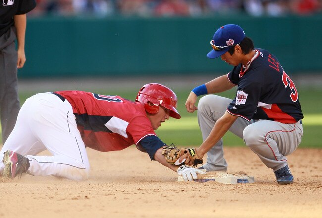 ANAHEIM, CA - JULY 11:  World Futures All-Star Hak-Ju Lee #31 of the Chicago Cubs applies a tag on U.S. Futures All-Star Mike Trout #20 of the Los Angeles Angels of Anaheim during the 2010 XM All-Star Futures Game at Angel Stadium of Anaheim on July 11, 2010 in Anaheim, California.  (Photo by Jeff Gross/Getty Images)