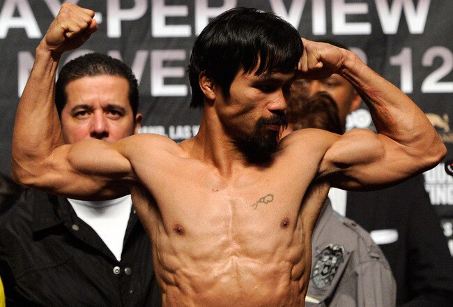 LAS VEGAS, NV - NOVEMBER 11:  Boxer Manny Pacquiao steps on the scale to weigh 143 pounds during the official weigh-in for his bout against Juan Manuel Marquez at the MGM Grand Garden Arena November 11, 2011 in Las Vegas, Nevada. Pacquiao will defend his WBO welterweight title against Marquez when the two meet in the ring for the third time on November 12 in Las Vegas.  (Photo by Ethan Miller/Getty Images)