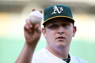 OAKLAND, CA - JUNE 14:  Starting pitcher Trevor Cahill #53 of the Oakland Athletics throws a ball to a fan against the Kansas City Royals at the Oakland-Alameda County Coliseum on June 14, 2011 in Oakland, California.  (Photo by Jed Jacobsohn/Getty Images)