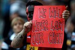 LONDON, ENGLAND - MARCH 27:  A fan displays a banner in memory of the Christchurch earthquake  ahead of the round six Super Rugby match between the Crusaders and the Sharks at Twickenham Stadium on March 27, 2011 in London, United Kingdom.  (Photo by Warren Little/Getty Images)