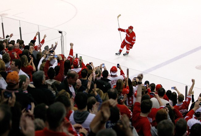 DETROIT, MI - FEBRUARY 14: Darren Helm #43 of the Detroit Red Wings salutes fans as the second star of the game after the Red Wings NHL record breaking 21st consecutive home victory defeating the Dallas Stars 3-1 at Joe Louis Arena on February 14, 2012 in Detroit, Michigan. (Photo by Gregory Shamus/Getty Images)