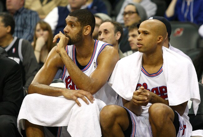 NEWARK, NJ - FEBRUARY 11:  (L-R) Tim Duncan #21 and Richard Jefferson #24 of the San Antonio Spurs look on from the bench against the New Jersey Nets at Prudential Center on February 11, 2012 in Newark, New Jersey.  NOTE TO USER: User expressly acknowledges and agrees that, by downloading and or using this photograph, User is consenting to the terms and conditions of the Getty Images License Agreement.  (Photo by Chris Chambers/Getty Images)