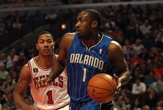 CHICAGO, IL - JANUARY 28: Gilbert Arenas #1 of the Orlando Magic moves past Derrick Rose #1 of the Chicago Bulls at the United Center on January 28, 2011 in Chicago, Illinois. The Bulls defeated the Magic 99-90. NOTE TO USER: User expressly acknowledges and agrees that, by downloading and/or using this photograph, User is consenting to the terms and conditions of the Getty Images License Agreement.  (Photo by Jonathan Daniel/Getty Images)