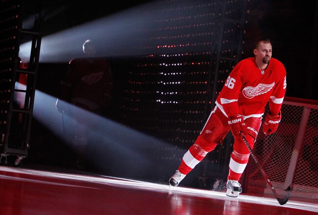 DETROIT, MI - OCTOBER 07:  Tomas Holmstrom #96 of the Detroit Red Wings is is introduced prior to playing the Ottawa Senators at Joe Louis Arena on October 7, 2011 in Detroit, Michigan. Detroit won the game 5-3. (Photo by Gregory Shamus/Getty Images)