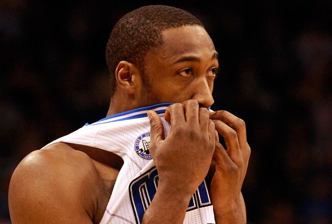 ORLANDO, FL - FEBRUARY 13:  Gilbert Arenas #1 of the Orlando Magic covers his mouth during the game against the Los Angeles Lakers at Amway Arena on February 13, 2011 in Orlando, Florida.  NOTE TO USER: User expressly acknowledges and agrees that, by downloading and or using this Photograph, user is consenting to the terms and conditions of the Getty Images License Agreement.  (Photo by Sam Greenwood/Getty Images)