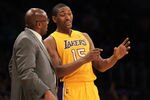 LOS ANGELES, CA - DECEMBER 27:  Metta World Peace #15  and Head coach Mike Brown of the Los Angeles Lakers talk during the game with the Utah Jazz at Staples Center on December 27, 2011 in Los Angeles, California.  The Lakers won 96-71.  NOTE TO USER: User expressly acknowledges and agrees that, by downloading and or using this photograph, User is consenting to the terms and conditions of the Getty Images License Agreement.  (Photo by Stephen Dunn/Getty Images)