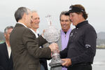 PEBBLE BEACH, CA - FEBRUARY 12:  Phil Mickelson smiles as he is awarded the tournament trophy after winning with an eight-under-par 64 during the AT&T Pebble Beach National Pro-Am at Pebble Beach Golf Links on February 12, 2012 in Pebble Beach, California.  (Photo by Ezra Shaw/Getty Images)