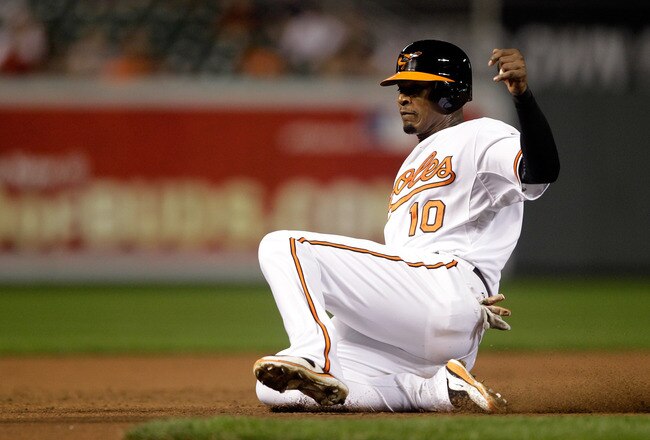 BALTIMORE, MD - SEPTEMBER 27:  Adam Jones #10 of the Baltimore Orioles steals third base against the Boston Red Sox Oriole Park at Camden Yards on September 27, 2011 in Baltimore, Maryland.  (Photo by Rob Carr/Getty Images)