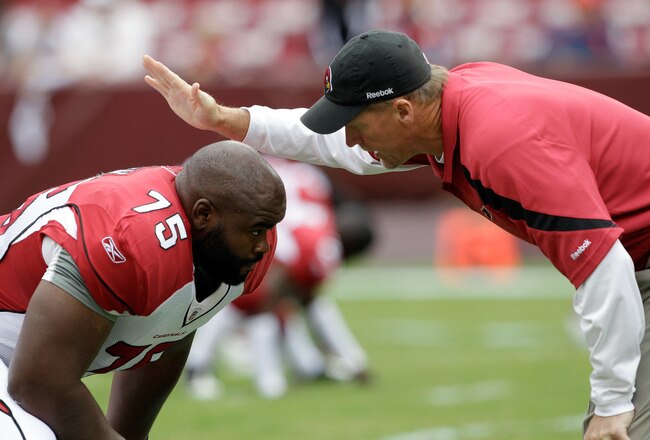 LANDOVER, MD - SEPTEMBER 18: Head coach Ken Whisenhunt of the Arizona Cardinals talks with Levi Brown #75 before the start of their game against the Washington Redskins at FedExField on September 18, 2011 in Landover, Maryland.  (Photo by Rob Carr/Getty Images)
