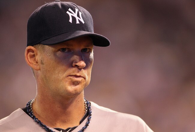 KANSAS CITY, MO - AUGUST 15:  Starting pitcher A.J. Burnett #34 of the New York Yankees walks off the field after being pulled during the 6th inning of the game against the Kansas City Royals at Kauffman Stadium on August 15, 2011 in Kansas City, Missouri.  (Photo by Jamie Squire/Getty Images)