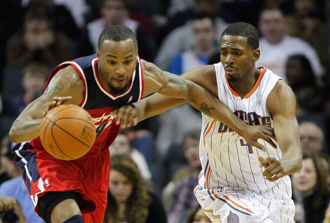 CHARLOTTE, NC - JANUARY 28:  Rashard Lewis #9 of the Washington Wizards and Derrick Brown #4 of the Charlotte Bobcats battle for a ball during their game at Time Warner Cable Arena on January 28, 2012 in Charlotte, North Carolina. NOTE TO USER: User expressly acknowledges and agrees that, by downloading and or using this photograph, User is consenting to the terms and conditions of the Getty Images License Agreement.  (Photo by Streeter Lecka/Getty Images)