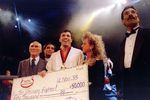 Jiu-Jitsu black belt Royce Gracie (USA) receives a $50,000 check after becoming 'The Ultimate Fighter' by defeating Gerard Gordeau of the Netherlands int he finals of the Ultimate Fighter Championships in Denver, Colorado.  Mandatory Credit: Markus Boesch