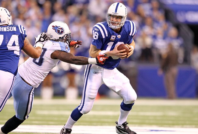 INDIANAPOLIS - JANUARY 02:  Peyton Manning #18 of the Indianapolis Colts looks to pass the ball while defended by Jacob Ford #78 of the Tennessee Titans during the NFL game at Lucas Oil Stadium on January 2, 2011 in Indianapolis, Indiana.  (Photo by Andy Lyons/Getty Images)