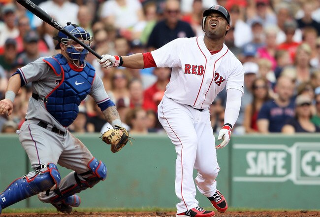 BOSTON, MA - SEPTEMBER 04:  Carl Crawford #13 of the Boston Red Sox reacts after striking out in the second inning as Mike Napoli #25 of the Texas Rangers catches on September 4, 2011 at Fenway Park in Boston, Massachusetts.  (Photo by Elsa/Getty Images)