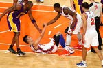 NEW YORK, NY - FEBRUARY 10:  Jeremy Lin #17 of the New York Knicks is helped up by teammate Iman Shumpert #21 and Kobe Bryant #24 of the Los Angeles Lakers at Madison Square Garden on February 10, 2012 in New York City.  NOTE TO USER: User expressly acknowledges and agrees that, by downloading and or using this photograph, User is consenting to the terms and conditions of the Getty Images License Agreement.  (Photo by Chris Chambers/Getty Images)