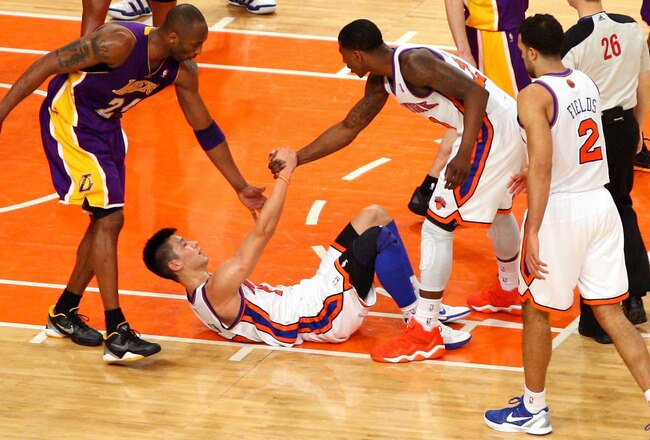 NEW YORK, NY - FEBRUARY 10:  Jeremy Lin #17 of the New York Knicks is helped up by teammate Iman Shumpert #21 and Kobe Bryant #24 of the Los Angeles Lakers at Madison Square Garden on February 10, 2012 in New York City.  NOTE TO USER: User expressly acknowledges and agrees that, by downloading and or using this photograph, User is consenting to the terms and conditions of the Getty Images License Agreement.  (Photo by Chris Chambers/Getty Images)