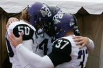 BOISE, ID - NOVEMBER 12:  Daniel Shelley #50, Anson Kelton #4, and Ross Evans #37 of the TCU Horned Frogs psyche up before the game against the Boise State Broncos at Bronco Stadium on November 12, 2011 in Boise, Idaho.  (Photo by Otto Kitsinger III/Getty Images)