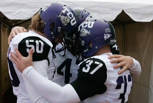 BOISE, ID - NOVEMBER 12:  Daniel Shelley #50, Anson Kelton #4, and Ross Evans #37 of the TCU Horned Frogs psyche up before the game against the Boise State Broncos at Bronco Stadium on November 12, 2011 in Boise, Idaho.  (Photo by Otto Kitsinger III/Getty Images)