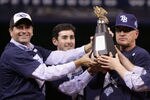 ST PETERSBURG, FL - OCTOBER 19:  Principal owner of the Tampa Bay Devil Rays, Stuart Sternberg (L) and manager Joe Maddon (R) celebrate with the American League Champion's trophy after defeating the Boston Red Sox in game seven of the American League Championship Series during the 2008 MLB playoffs on October 19, 2008 at Tropicana Field in St Petersburg, Florida.  The Rays defeated the Red Sox 3-1 to win the series 4-3.  (Photo by Doug Pensinger/Getty Images)