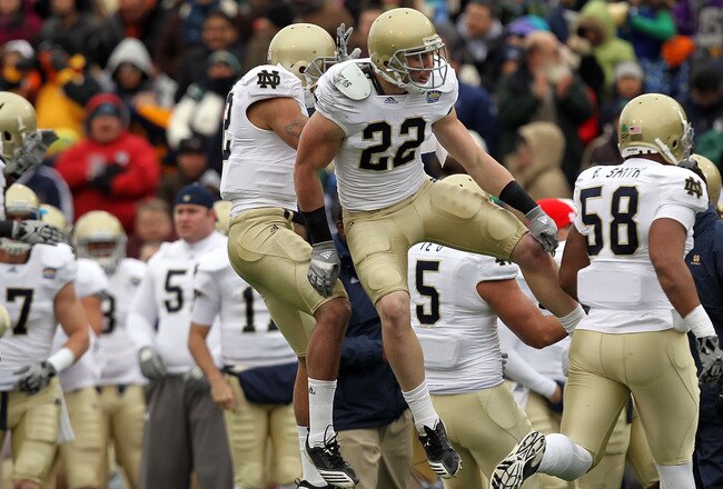 EL PASO, TX - DECEMBER 30:  Safety Harrison Smith #22 celebrates a pass interception with Robert Blanton #12 of the Notre Dame Fighting Irish during play against the Miami Hurricanes at Sun Bowl on December 30, 2010 in El Paso, Texas.  (Photo by Ronald Martinez/Getty Images)