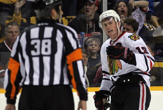 NASHVILLE, TN - FEBRUARY 14: Jonathan Toews #19 of the Chicago Blackhawks argues a first period penalty call with referee Francois St. Laurent #38 in the game against the Nashville Predators at the Bridgestone Arena on February 14, 2012 in Nashville, Tennessee.  (Photo by Bruce Bennett/Getty Images)