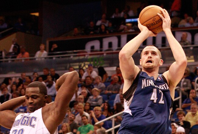 ORLANDO, FL - NOVEMBER 03:  Kevin Love #42 of the Minnesota Timberwolves attempts a shot over Brandon Bass #30 of the Orlando Magic during the game at Amway Arena on November 3, 2010 in Orlando, Florida.  NOTE TO USER: User expressly acknowledges and agrees that, by downloading and or using this Photograph, user is consenting to the terms and conditions of the Getty Images License Agreement.  (Photo by Sam Greenwood/Getty Images)