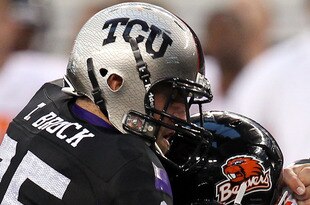 ARLINGTON, TX - SEPTEMBER 04:  Quarterback Ryan Katz #12 of the Oregon State Beavers is tackled by Tanner Brock #35 of the TCU Horned Frogs at Cowboys Stadium on September 4, 2010 in Arlington, Texas.  (Photo by Ronald Martinez/Getty Images)