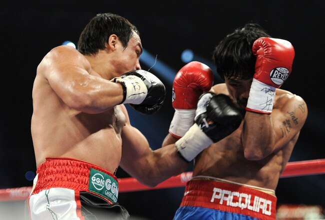 LAS VEGAS, NV - NOVEMBER 12:  (L-R) Juan Manuel Marquez throws a left to the head of Manny Pacquiao during the WBO world welterweight title fight at the MGM Grand Garden Arena on November 12, 2011 in Las Vegas, Nevada.  (Photo by Harry How/Getty Images)